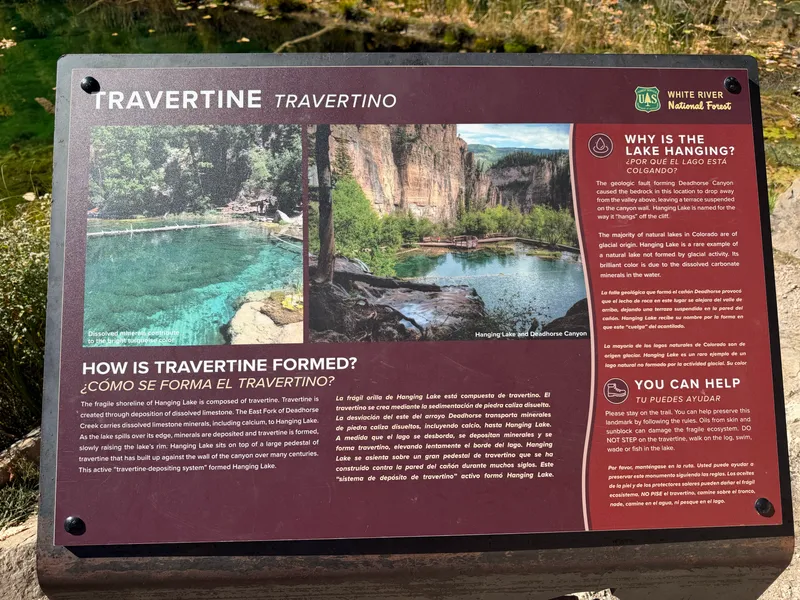 Forest Service interpretive sign explaining how travertine forms and why Hanging Lake hangs.
